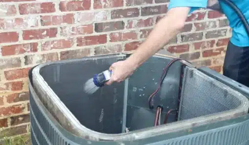 spraying dirty ac condensor coils to clean them