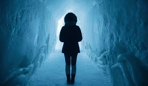 woman standing comfortably protected in frozen tunnel after credit freeze